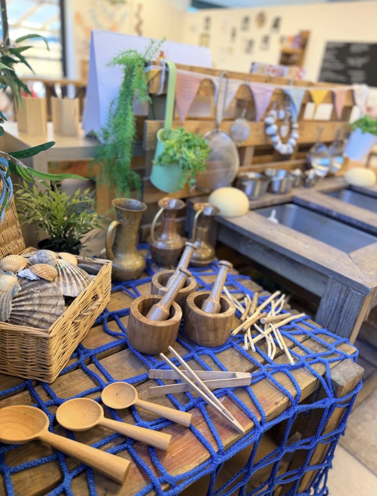 A Curiosity Approach provocation with natural loose parts, wooden spoons and shells at Wibli Wobli Newport