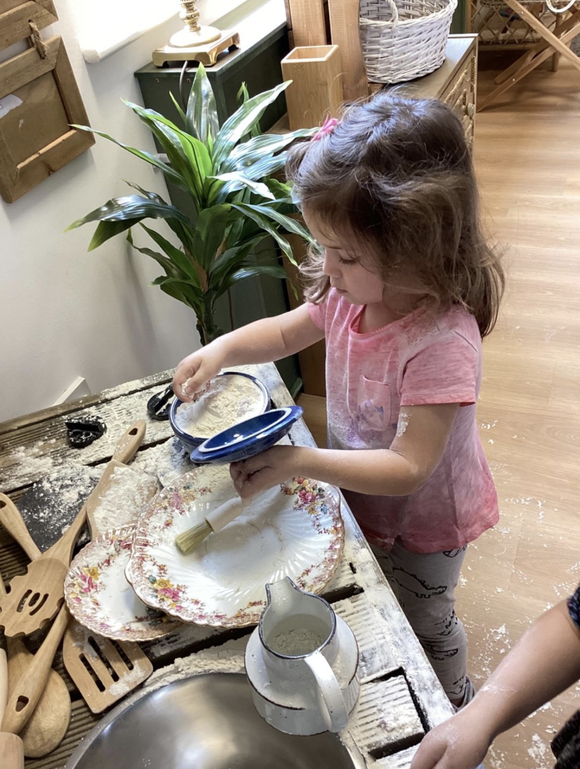A child enjoying messy flour play at Wibli Wobli